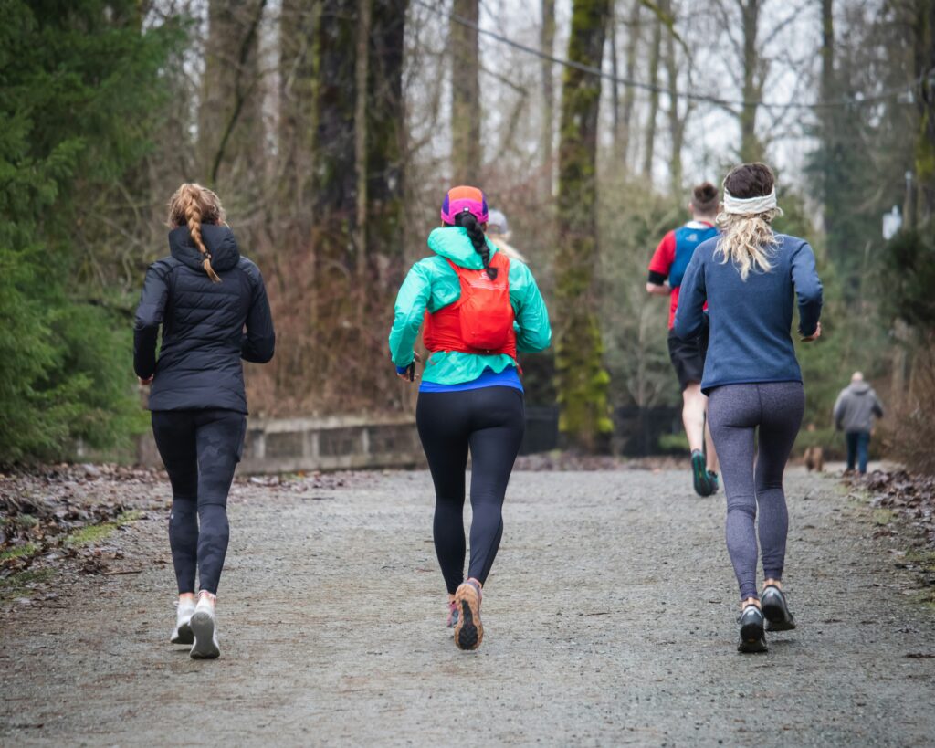 Three women running in winter.