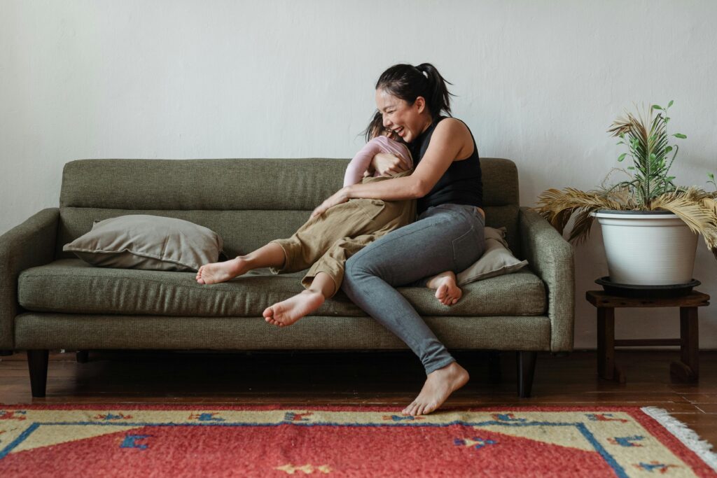 Image of woman hugging her child on the sofa.