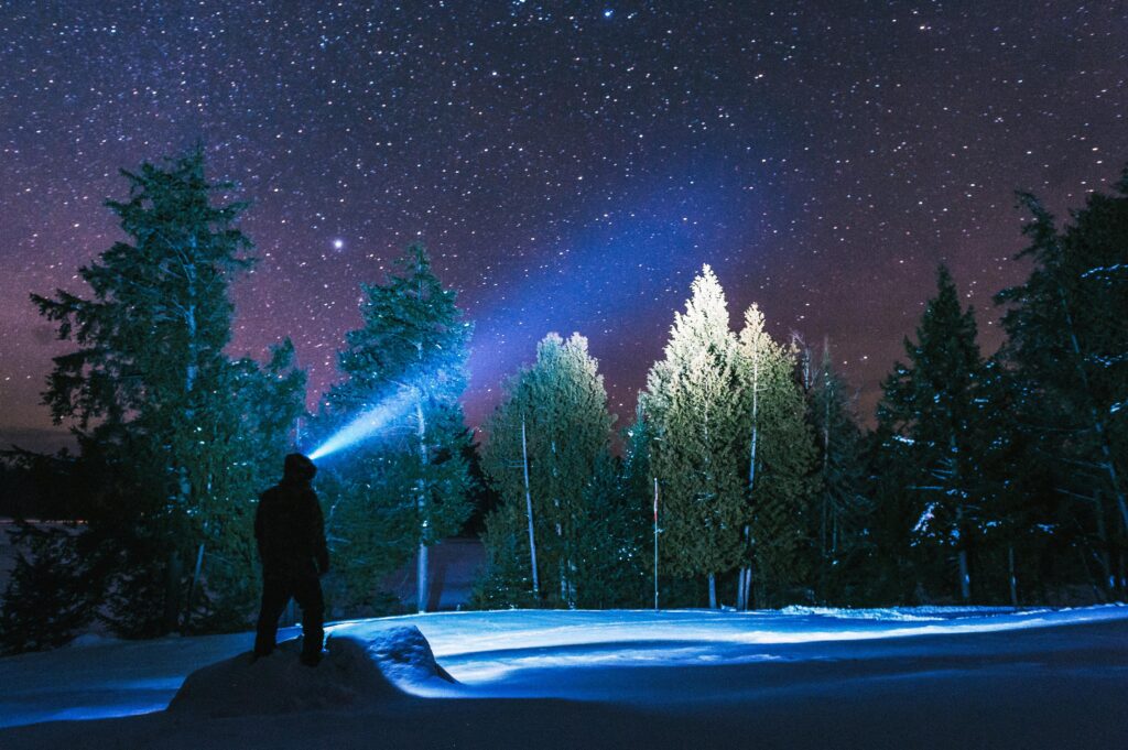 Hiking person wearing a head torch in the dark.