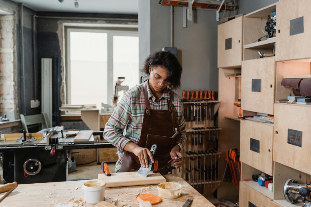 Woman in a workshop creating her furniture makeover.