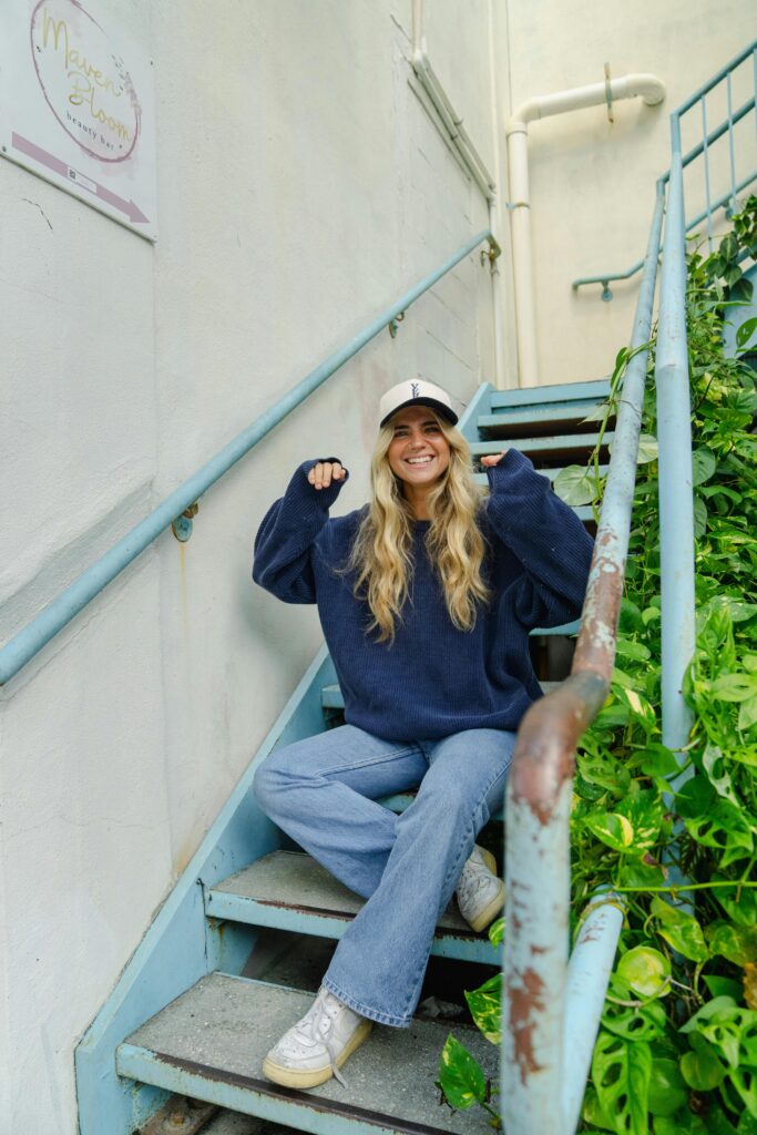 Woman breaking fashion norms of yesteryear in an oversized sweater and jeans.