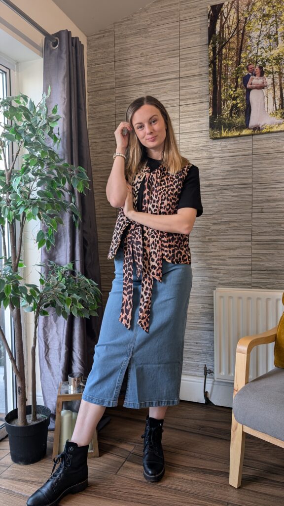 Denim mid skirt styled with leopard gilet.