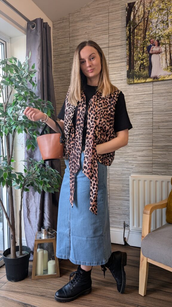 Denim mid skirt styled with leopard gilet.