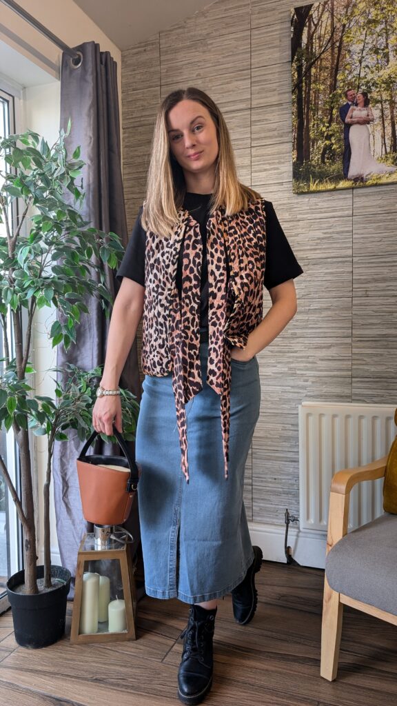 Denim mid skirt styled with leopard gilet.