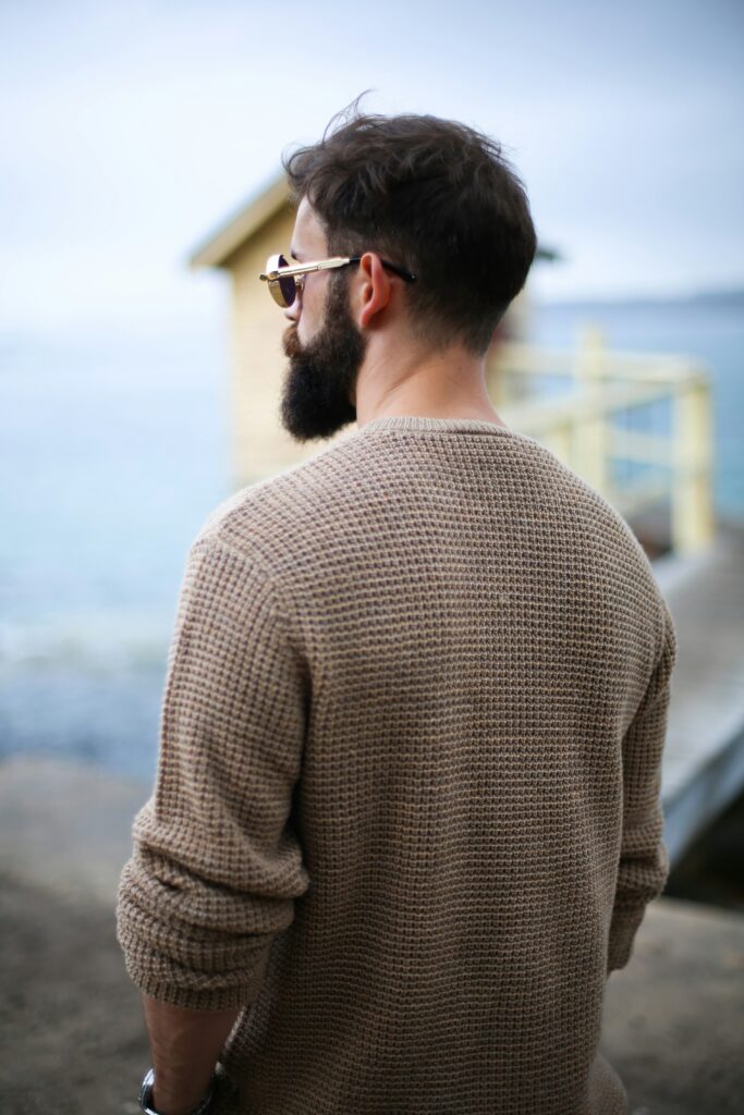 Man wearing a cable knit jumper.