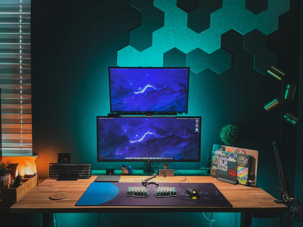 Gaming consoles on a desk set up.