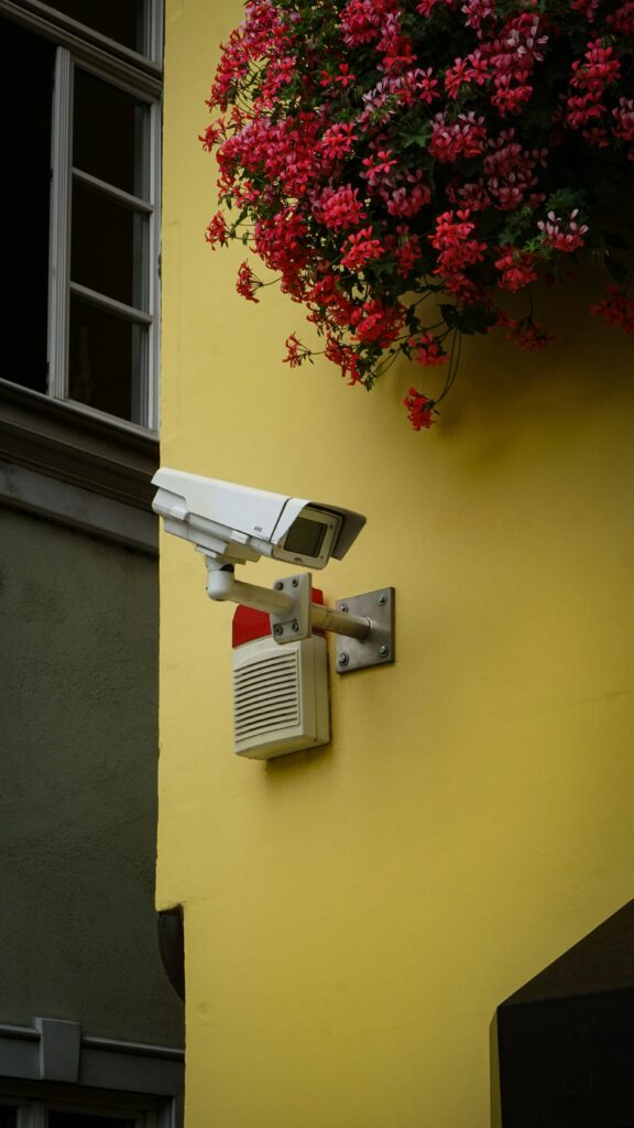 Security camera system on brightly coloured wall.