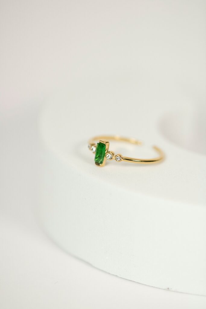 Emerald green sustainable engagement ring.