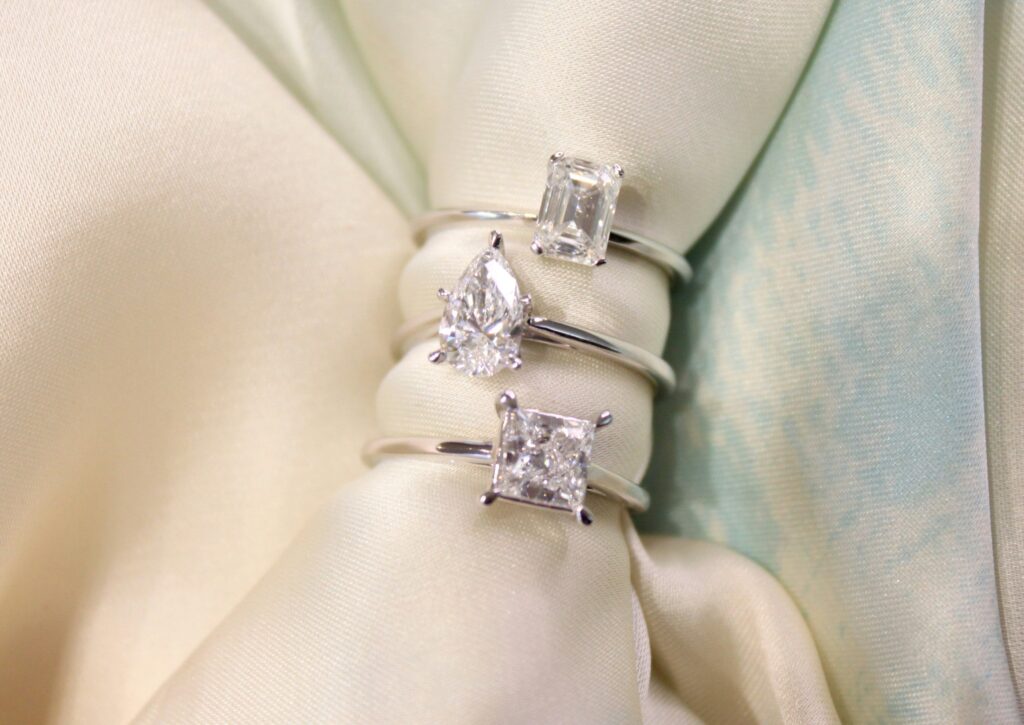 Three sustainable engagement ring designs.