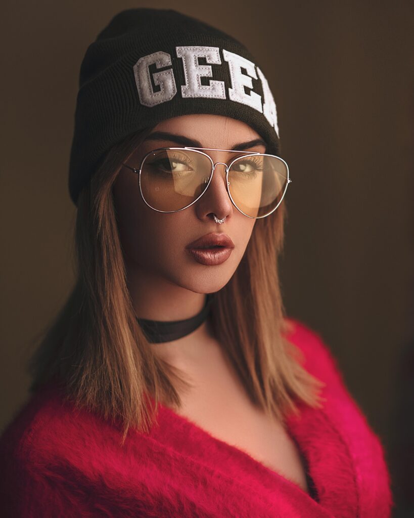 Woman wearing a hat embroidered with the word geek.
