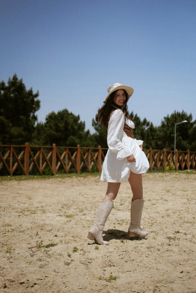 Cowboy boots styled with a white floaty dress.