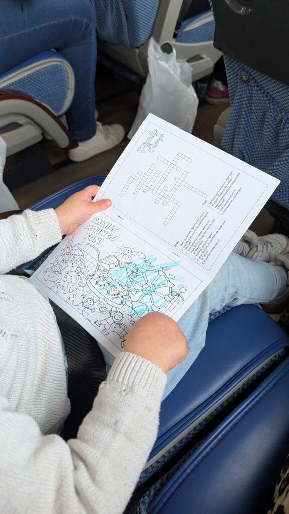 Colouring in the Family Outings activity pack.