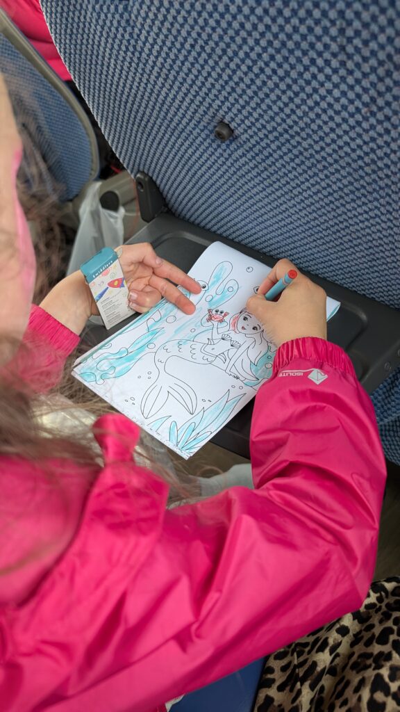 Colouring in a colouring book on. acoach.