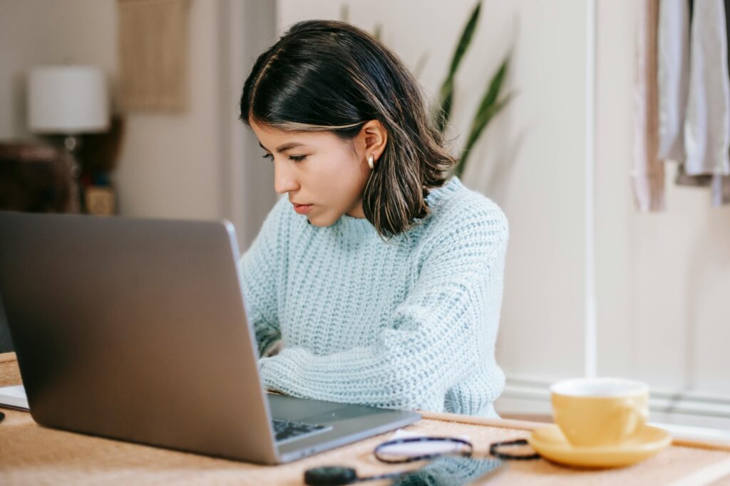 Woman learning at a laptop screen.