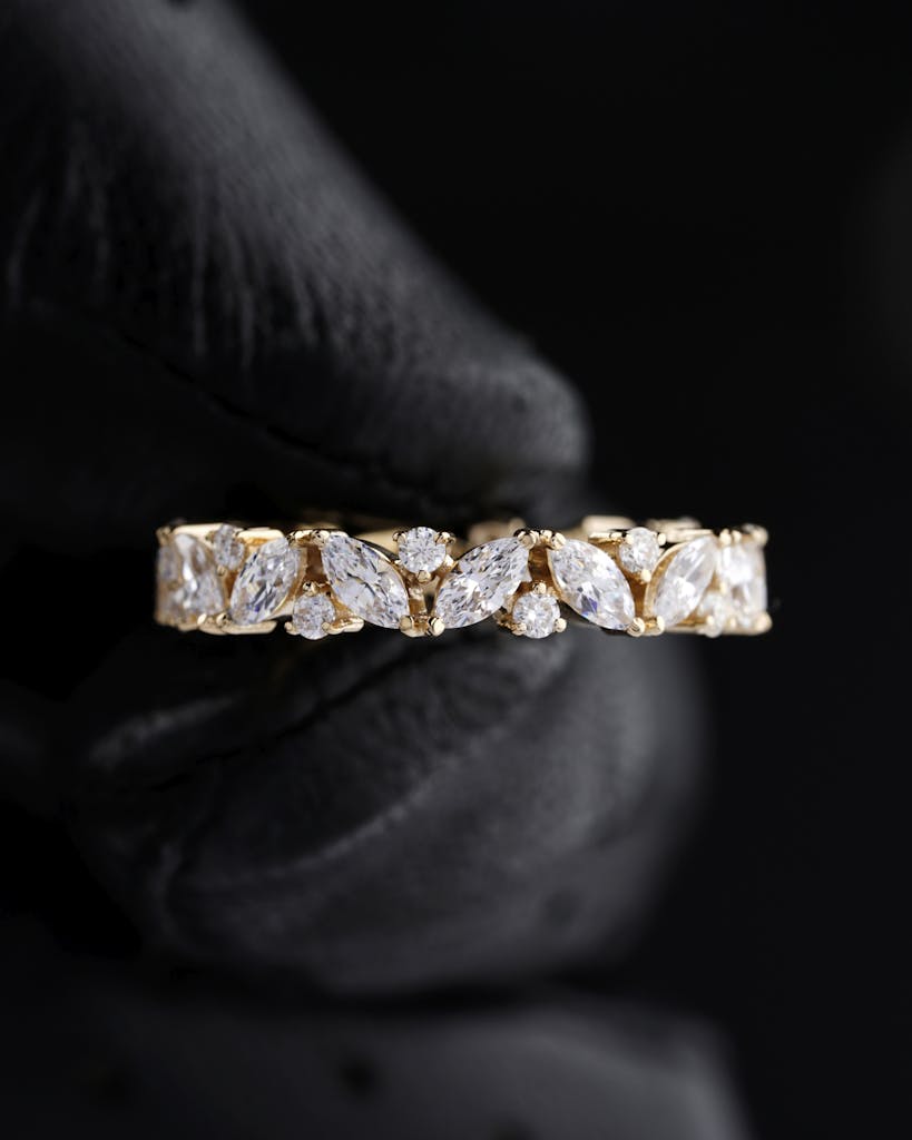Close-up of a luxurious diamond ring with a gold band, showcasing intricate craftsmanship.