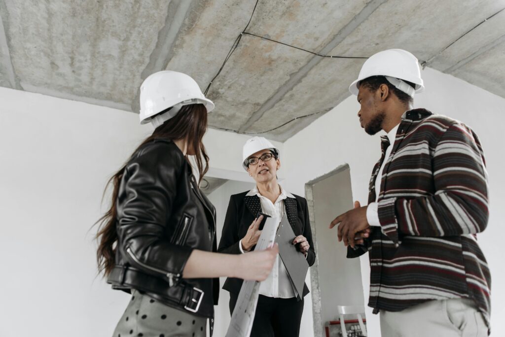 People gathering round building site with business safety documentation.