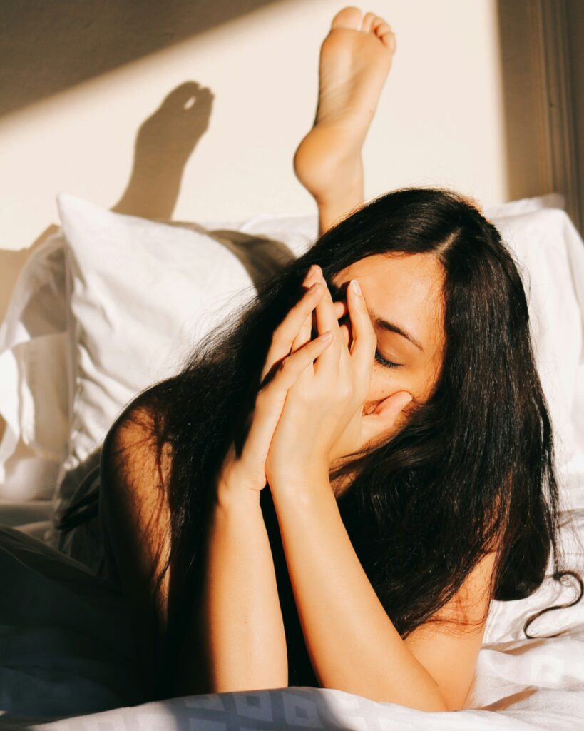 Tied woman with signs of fatigue around the eyes.