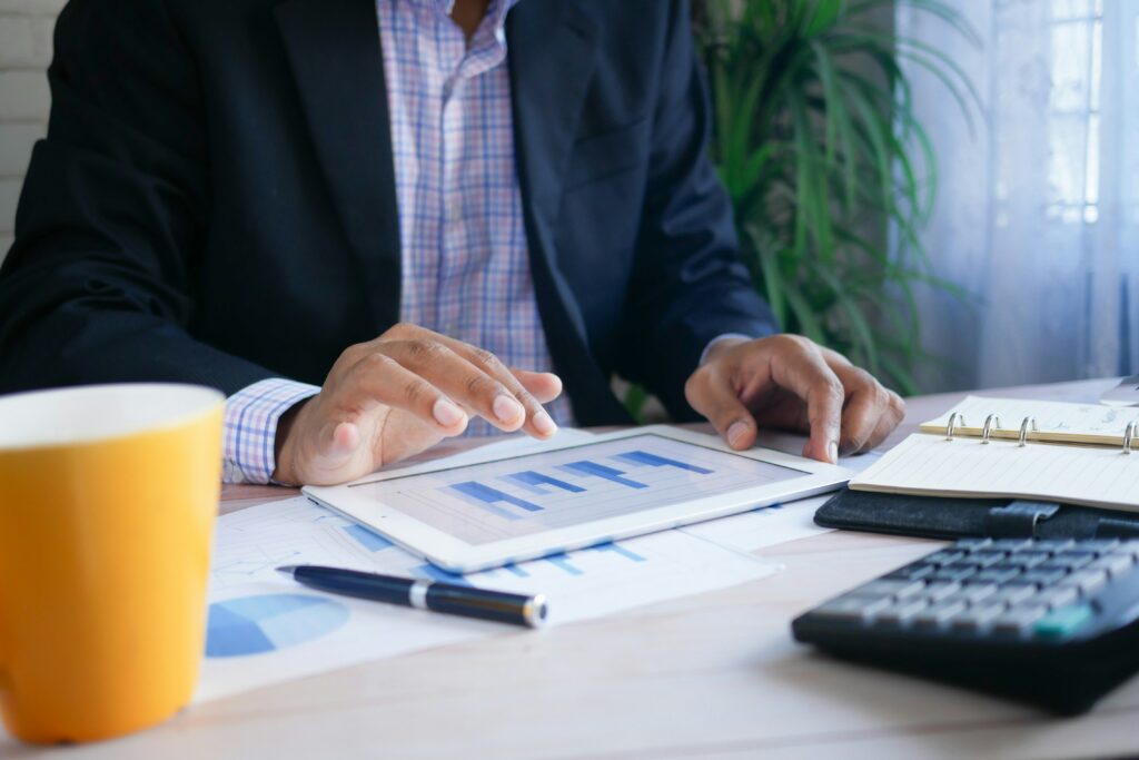 Businessman on a tablet, screen shows digital agency growth.