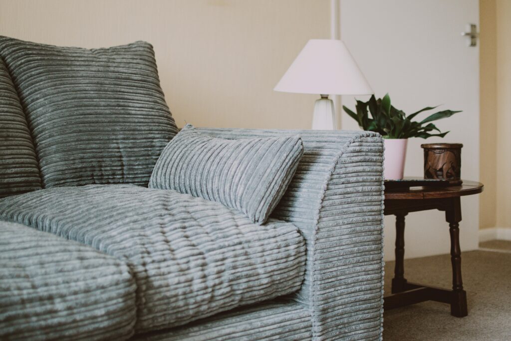 Grey green textured sofa.