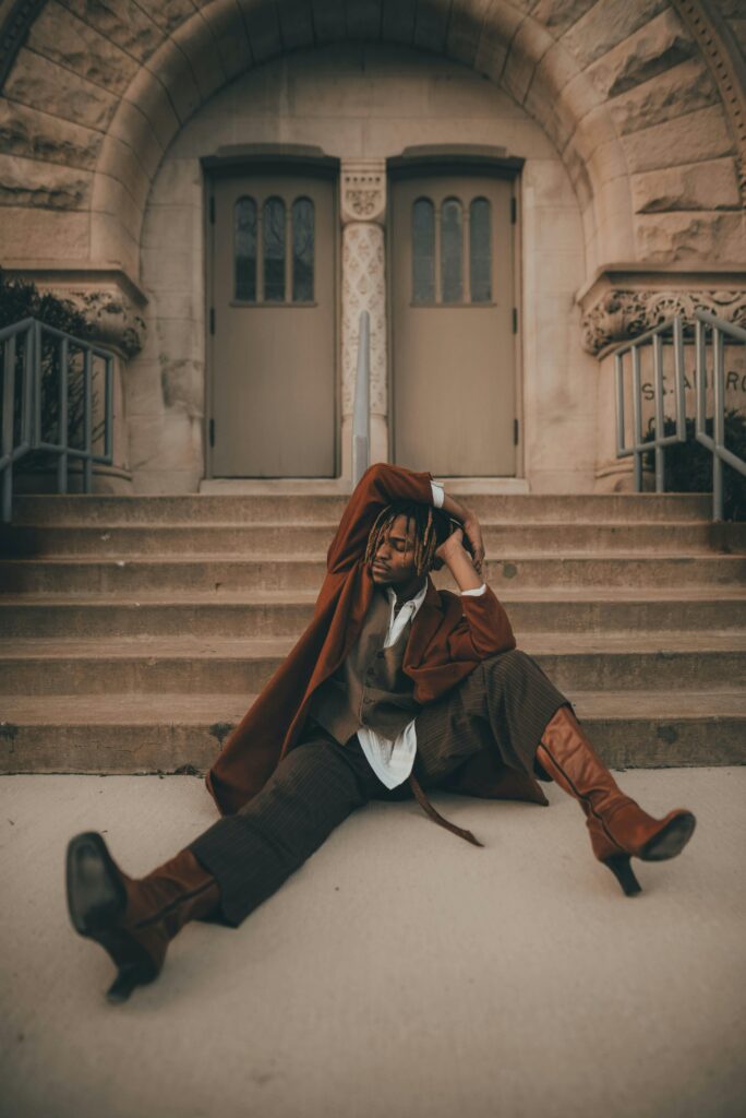 Man wearing culottes and knee high boots.