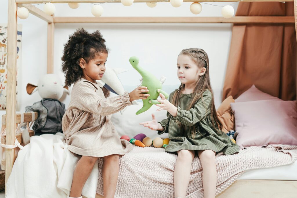 Two children sharing toys.