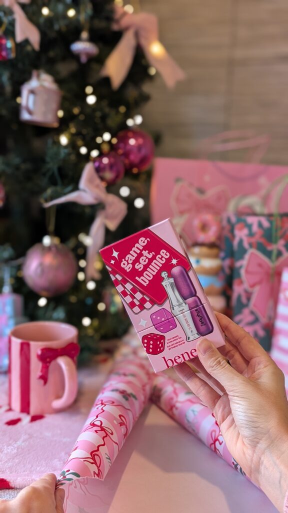 Wrapping a Benefit brow kit with pink Christmas wrapping to create a cohesive Christmas.