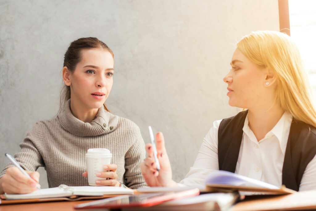 Two business women discussing marketing techniques.
