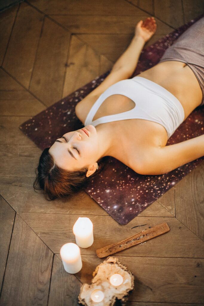 Woman laid on a yoga mat practicing mindfulness. This is especially important in modern life.