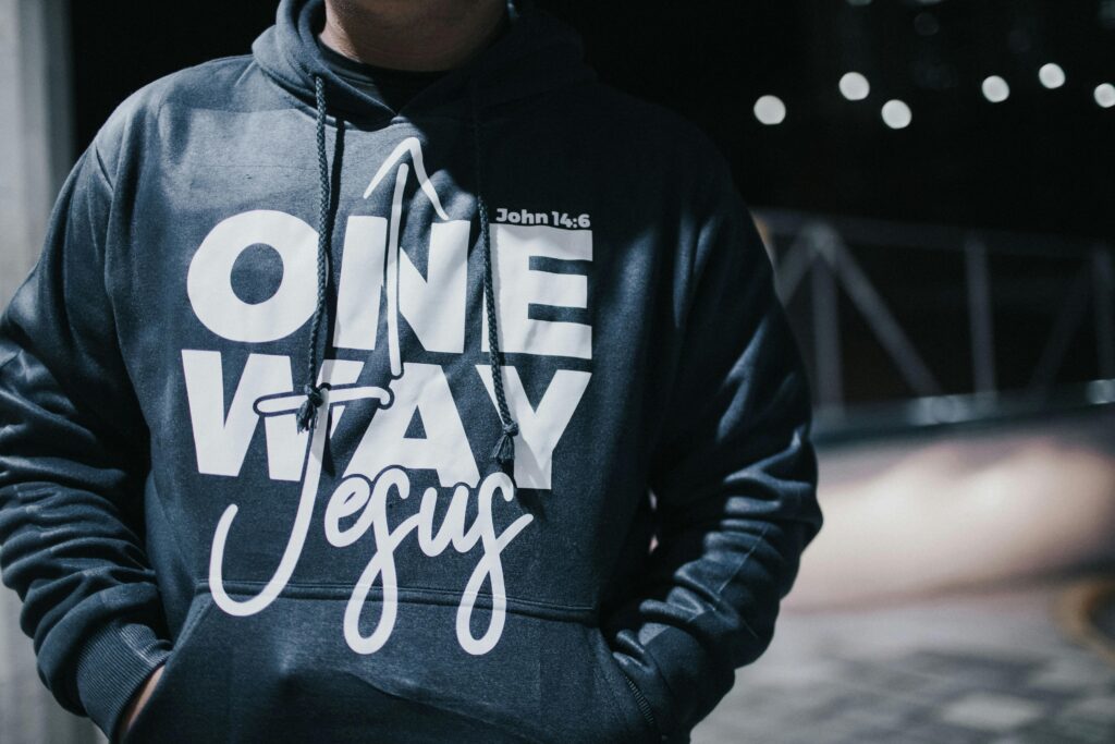 Man wearing faith inspired fashion, a Christian hoodie which says 'one way Jesus'.