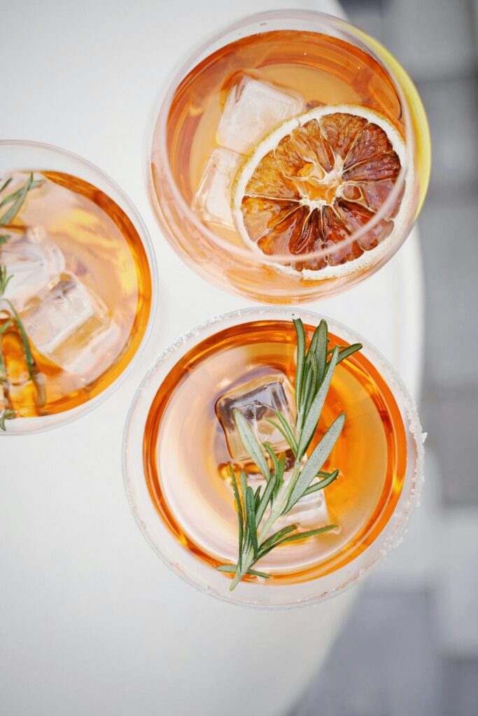 top down view of three orange based cocktails.