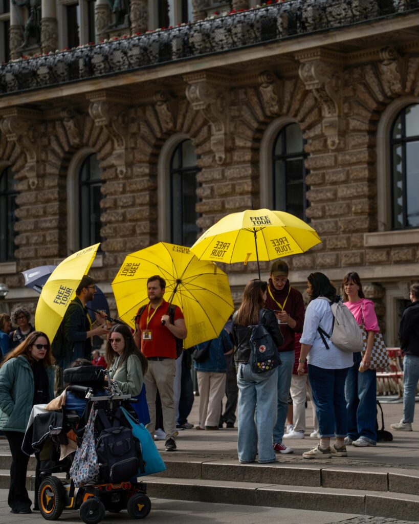 Tour guide waiting with umbrella.
