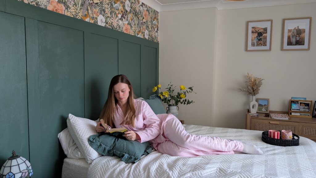 Mother's Day blog post with British Boxers. Claire Mac laid on a bed reading wearing pink striped pyjamas.