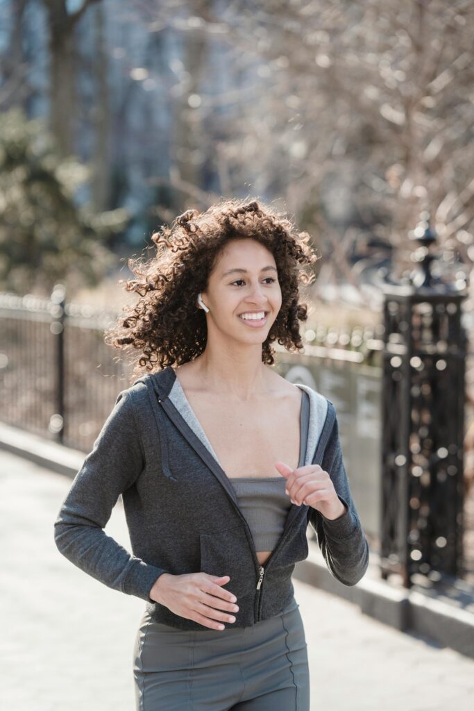 Woman enjoying slow running through the park.