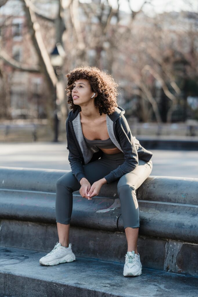 Lady sitting down after going for a run.