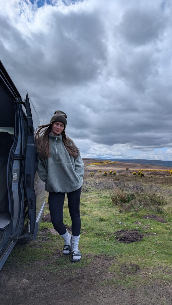 Claire Mac wearing spring layering outfit in North Yorkshire campervan.