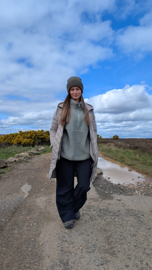 Claire Mac wearing a quarter zip fleece.