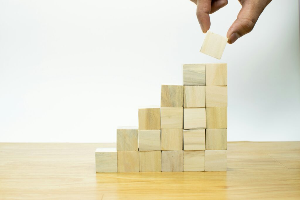 person stacking blocks, this is meant to represent predictable business growth.