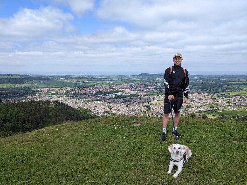 Man walking a dog overlooking Teesside.