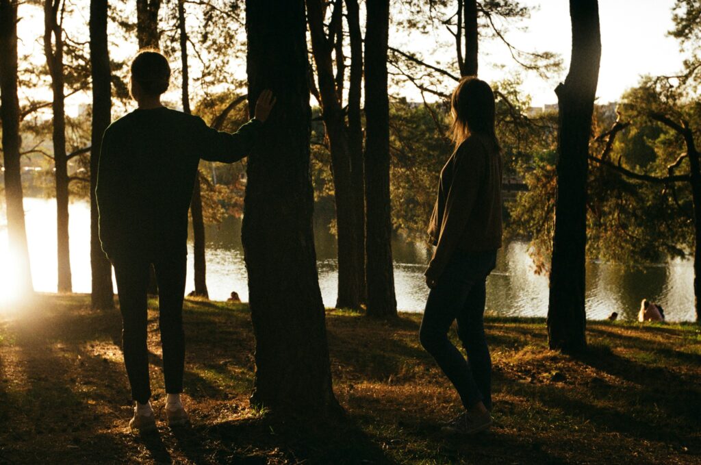Couple stood in a woodlands, moody image to go with a post about handling difficult situatiosn.