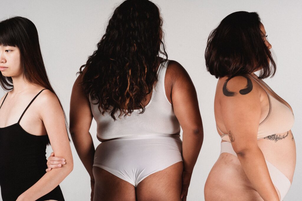 Body image: Three women with different bodies posing together.
