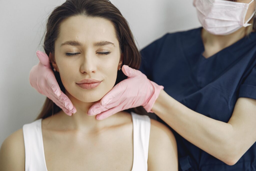 Woman getting treatment consultation for facial and neck rejuvenation.